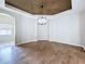 Dining room featuring wood floors, neutral paint, and modern lighting at 1919 Oswego Dr, Holiday, FL 34691