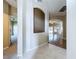 Open entryway showcasing the living room and hall to carpeted bedroom at 1919 Oswego Dr, Holiday, FL 34691