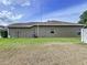 Side exterior view of the home showing the lawn, siding and windows at 1919 Oswego Dr, Holiday, FL 34691