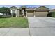 Single-Gathering home featuring a three-car garage, lush lawn and inviting entrance at 1919 Oswego Dr, Holiday, FL 34691