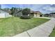 Beautiful curb appeal of this home showing the lawn, driveway and mature landscaping at 1919 Oswego Dr, Holiday, FL 34691