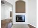 Tiled fireplace with dark metal door and decorative mantel ready to warm your home at 1919 Oswego Dr, Holiday, FL 34691