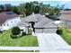 Charming single-story home featuring a well-manicured lawn and a convenient two-car garage at 1919 Oswego Dr, Holiday, FL 34691