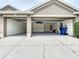 Spacious two-car garage with open doors and an epoxy floor for easy maintenance at 1919 Oswego Dr, Holiday, FL 34691