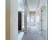 Hallway showcasing neutral paint and carpeting with a glimpse of the front door at 1919 Oswego Dr, Holiday, FL 34691