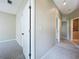 Hallway with neutral carpeting leading to other rooms, showcasing the home's layout at 1919 Oswego Dr, Holiday, FL 34691
