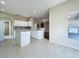 Open concept kitchen with white cabinets, an island, and tile flooring at 1919 Oswego Dr, Holiday, FL 34691