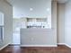 A view of an open kitchen that features light-colored cabinets and modern appliances at 1919 Oswego Dr, Holiday, FL 34691