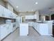 Spacious kitchen with stainless appliances, a center island, and a tiled backsplash at 1919 Oswego Dr, Holiday, FL 34691