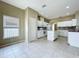 Bright kitchen with white cabinets, tile floors, and a kitchen island at 1919 Oswego Dr, Holiday, FL 34691