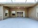 Spacious outdoor lanai with neutral wall paint and sliding glass doors providing backyard view at 1919 Oswego Dr, Holiday, FL 34691