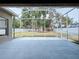 Screened-in patio with neutral flooring offering a view of the fenced-in backyard, perfect for entertaining at 1919 Oswego Dr, Holiday, FL 34691