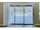 A view of an outdoor screened-in patio from inside the house, showing sliding glass doors at 1919 Oswego Dr, Holiday, FL 34691