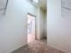 Walk-in closet with neutral carpeting, white walls and access to the bathroom at 1919 Oswego Dr, Holiday, FL 34691