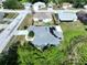 This aerial view shows a charming home featuring solar panels and a backyard with serene pond views at 21626 Rosewood Ct, Lutz, FL 33549
