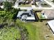 A view of a home with a screened in porch, solar panels, and a serene pond at 21626 Rosewood Ct, Lutz, FL 33549