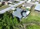 This aerial shot highlights the house's solar panels and a lovely view of the water at 21626 Rosewood Ct, Lutz, FL 33549