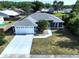 Stunning aerial view of a well-maintained home featuring a two-car garage, lush landscaping, and a spacious driveway at 21626 Rosewood Ct, Lutz, FL 33549