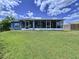 Well-maintained backyard showcasing the home's screened-in patio, perfect for outdoor relaxation at 21626 Rosewood Ct, Lutz, FL 33549