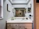 Bathroom with a white vanity, mirror, and view into the walk-in shower at 21626 Rosewood Ct, Lutz, FL 33549