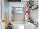 Bathroom with bathtub, shower, tile wall and small decorations on a wood shelf at 21626 Rosewood Ct, Lutz, FL 33549
