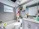 Bathroom featuring a tub, shower, and light vanity with decorative elements at 21626 Rosewood Ct, Lutz, FL 33549