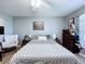 Bedroom with neutral tones, a world map wall hanging and a comfy armchair and wooden furniture at 21626 Rosewood Ct, Lutz, FL 33549