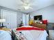 Bedroom featuring closet, ceiling fan, plants and decor at 21626 Rosewood Ct, Lutz, FL 33549