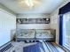 Bedroom features two cribs, nautical themed name art on wall, and a large window offering natural light at 21626 Rosewood Ct, Lutz, FL 33549