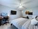 A bedroom with light gray walls, a ceiling fan, and workspace and furnishings, creating a functional aesthetic at 21626 Rosewood Ct, Lutz, FL 33549