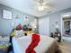 Bedroom with white ceiling fan, grey walls, closet and door to another room at 21626 Rosewood Ct, Lutz, FL 33549