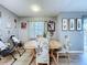 A dining area bathed in natural light, features a wooden table and chairs, with décor at 21626 Rosewood Ct, Lutz, FL 33549