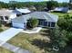 Well-maintained home featuring a two-car garage, manicured lawn, and mature landscaping at 21626 Rosewood Ct, Lutz, FL 33549