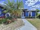 Inviting front entrance with tropical landscaping, leading to a home with a serene and welcoming facade at 21626 Rosewood Ct, Lutz, FL 33549