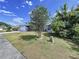Well-manicured front yard with mature tree offering shade and curb appeal at 21626 Rosewood Ct, Lutz, FL 33549