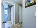 Bright hallway with white doors, neutral wall color, and wood-look tile flooring at 21626 Rosewood Ct, Lutz, FL 33549
