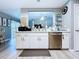 Modern kitchen with stainless steel appliances and white cabinets at 21626 Rosewood Ct, Lutz, FL 33549