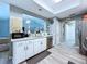 Bright kitchen featuring grey floors, stainless steel appliances and white cabinets at 21626 Rosewood Ct, Lutz, FL 33549