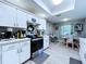 Bright kitchen area with stainless steel appliances, white cabinetry, and dining area at 21626 Rosewood Ct, Lutz, FL 33549