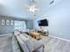 Comfortable living room features modern decor, ceiling fan and sliding glass doors at 21626 Rosewood Ct, Lutz, FL 33549