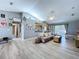 Bright living room with vaulted ceilings, modern gray floors, and neutral tones, creating an inviting space at 21626 Rosewood Ct, Lutz, FL 33549