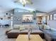 Spacious living area featuring vaulted ceilings, modern finishes, and a seamless flow to the dining and kitchen spaces at 21626 Rosewood Ct, Lutz, FL 33549