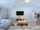 Comfortable living room featuring a large TV, modern decor, and plush seating, perfect for relaxation at 21626 Rosewood Ct, Lutz, FL 33549