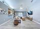 Bright living room with gray floors, vaulted ceilings, and seamless flow to the kitchen at 21626 Rosewood Ct, Lutz, FL 33549