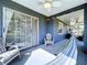 Cozy covered patio with a ceiling fan, Adirondack chairs, and a relaxing hammock at 21626 Rosewood Ct, Lutz, FL 33549