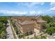 Aerial view of tan townhouses featuring street parking and tropical foliage at 2221 Soho Bay Ct, Tampa, FL 33606