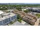 Aerial view of a townhouse complex near trees, the highway, and parking at 2221 Soho Bay Ct, Tampa, FL 33606
