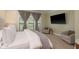 Bedroom suite featuring a wall-mounted TV, neutral palette, and plenty of natural light at 2221 Soho Bay Ct, Tampa, FL 33606