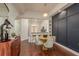 Dining area with wood floors, accent wall, open concept to kitchen area at 2221 Soho Bay Ct, Tampa, FL 33606