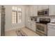 Bright kitchen with stainless steel appliances and window with shutters at 2221 Soho Bay Ct, Tampa, FL 33606